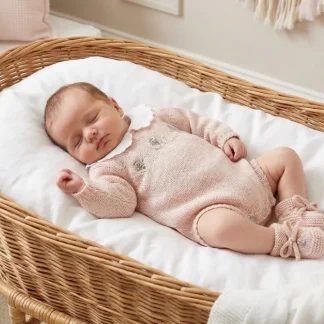 Knit romper with hand-embroidered flowers