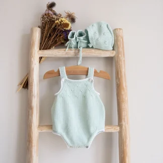 Knitted Romper with small cable details and white trim